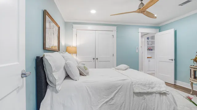 a bedroom with a bed and a mirror