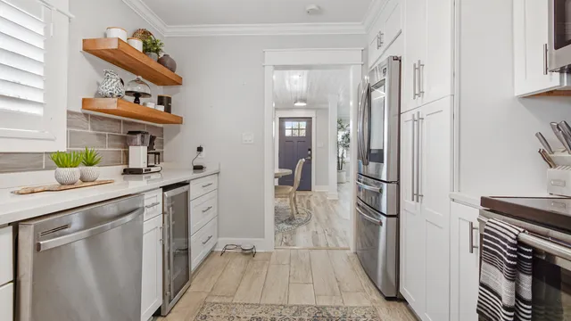 a kitchen with a sink appliances and cabinets