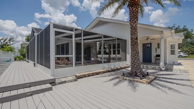 a view of house with backyard and sitting area