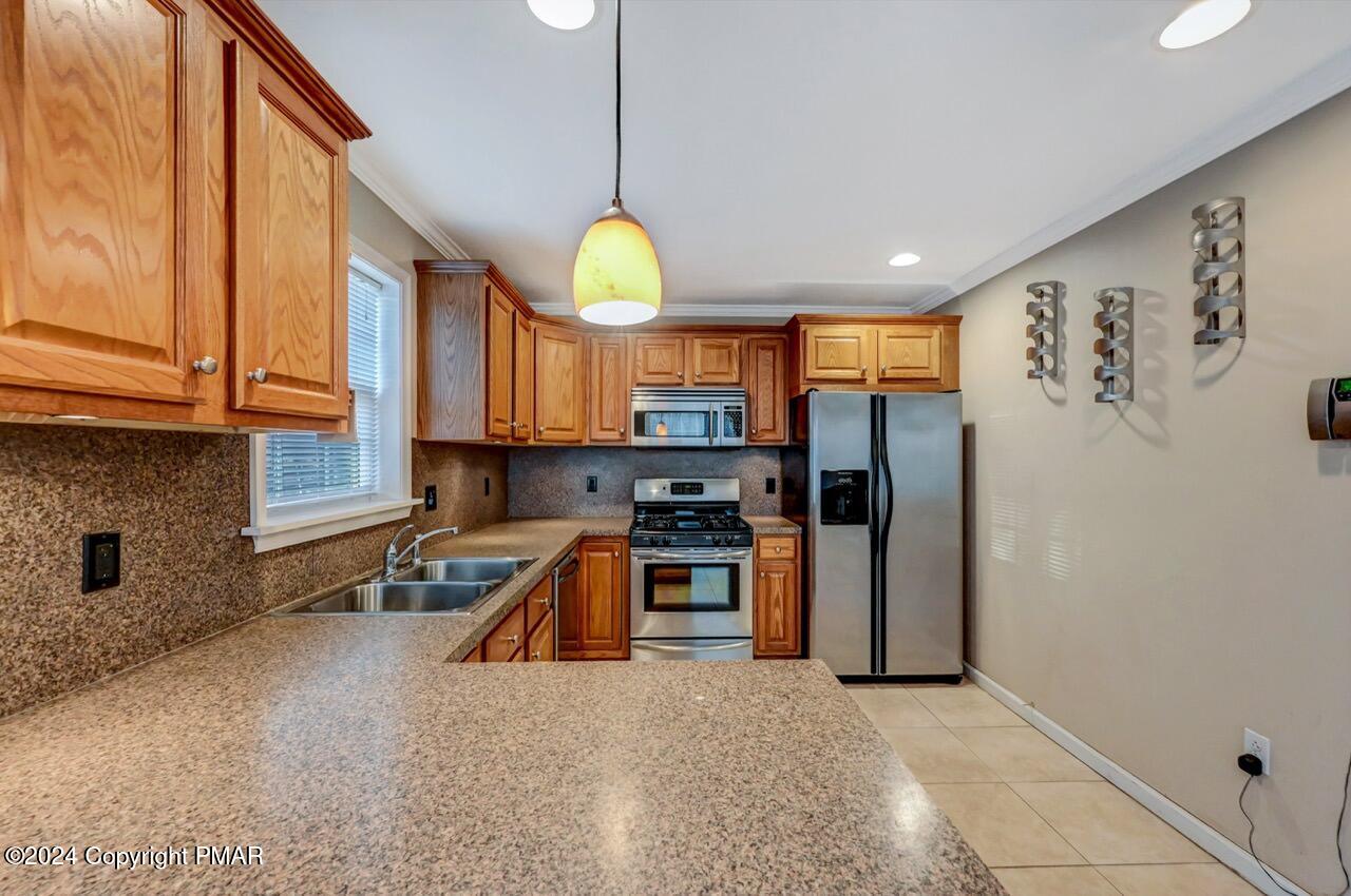119 Woodland Road Albrightsville, PA 18210 - Photo 11 of 45 a kitchen with stainless steel appliances a stove a refrigerator and a sink