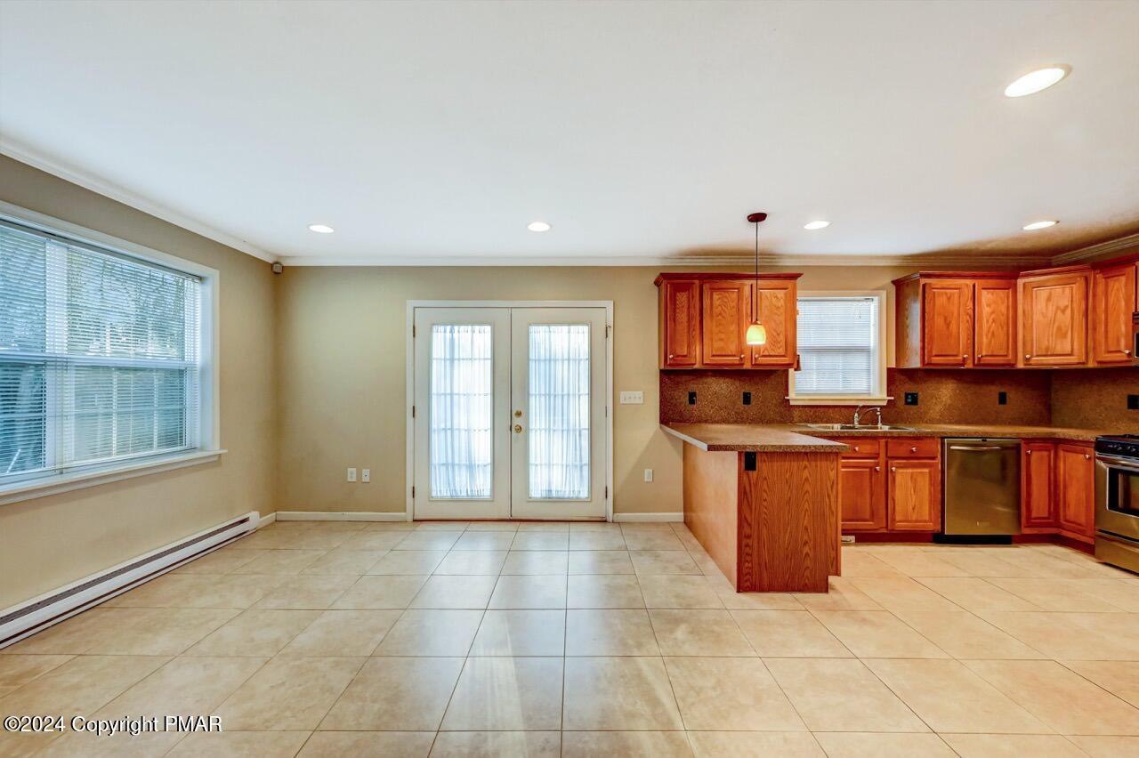 119 Woodland Road Albrightsville, PA 18210 - Photo 15 of 45 a large kitchen with stainless steel appliances granite countertop a stove top oven a sink dishwasher a dining table and chairs with wooden floor