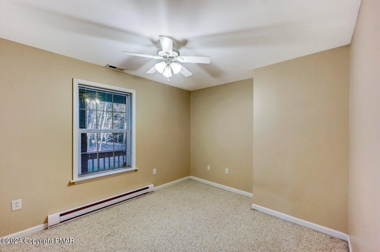 119 Woodland Road Albrightsville, PA 18210 - Photo 25 of 45 an empty room with windows and fan