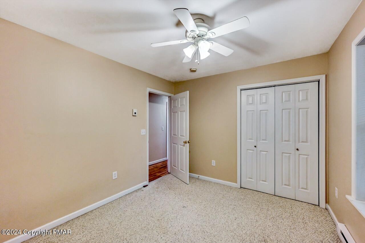 119 Woodland Road Albrightsville, PA 18210 - Photo 26 of 45 an empty room with a ceiling fan