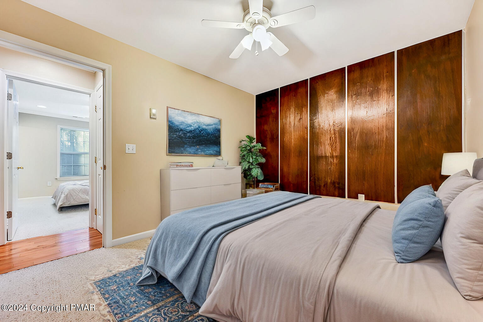 119 Woodland Road Albrightsville, PA 18210 - Photo 27 of 45 a bedroom with a large bed and a chandelier