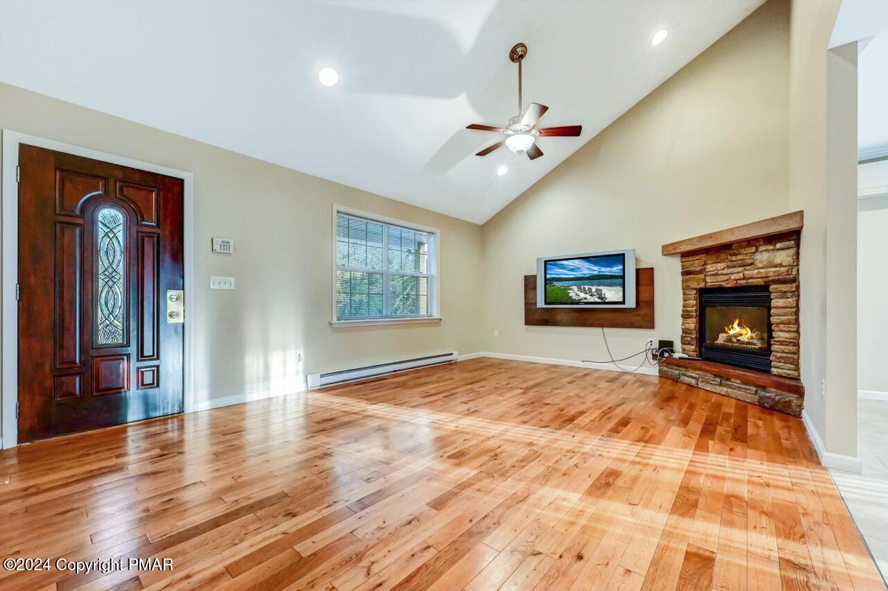 119 Woodland Road Albrightsville, PA 18210 - Photo 6 of 45 a view of an empty room with window and wooden floor