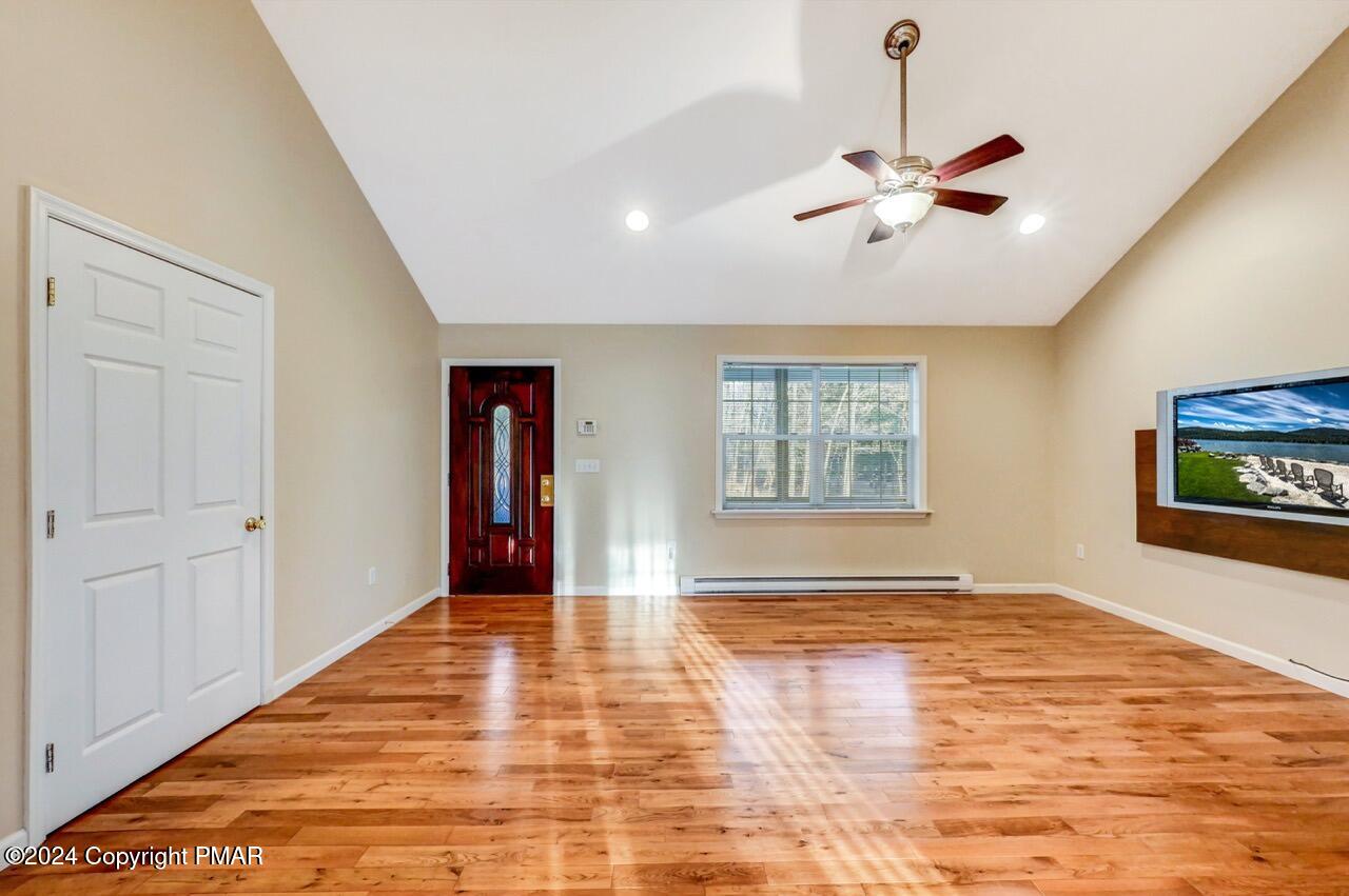 119 Woodland Road Albrightsville, PA 18210 - Photo 7 of 45 a view of an empty room with window and wooden floor