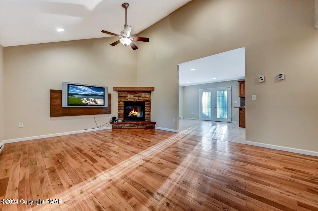119 Woodland Road Albrightsville, PA 18210 - Photo 8 of 45 a view of a livingroom with a fireplace a chandelier and wooden floor