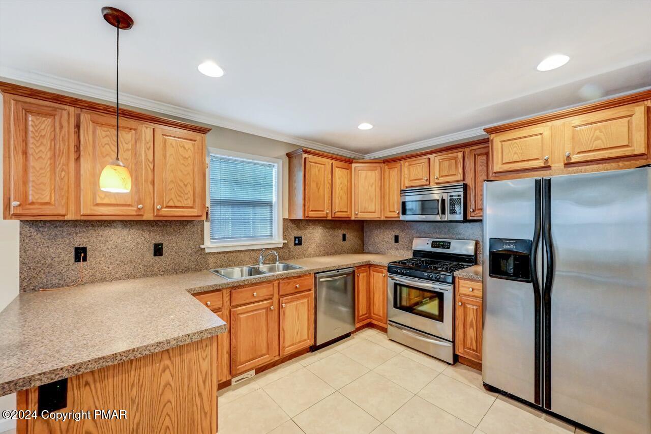 119 Woodland Road Albrightsville, PA 18210 - Photo 10 of 45 a kitchen with a sink a window and stainless steel appliances