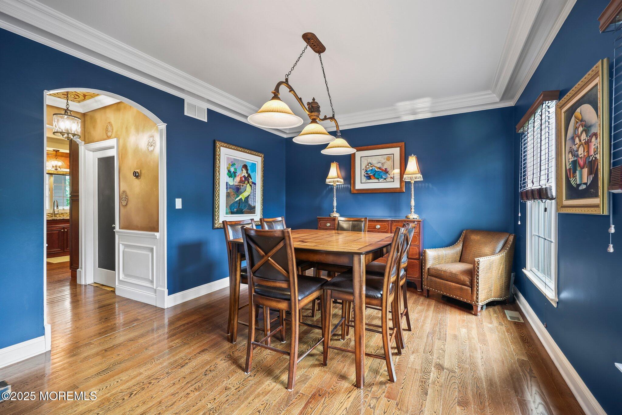 4 White Pines Way Freehold, NJ 07728 - Photo 12 of 66 a dining room with furniture a chandelier and wooden floor