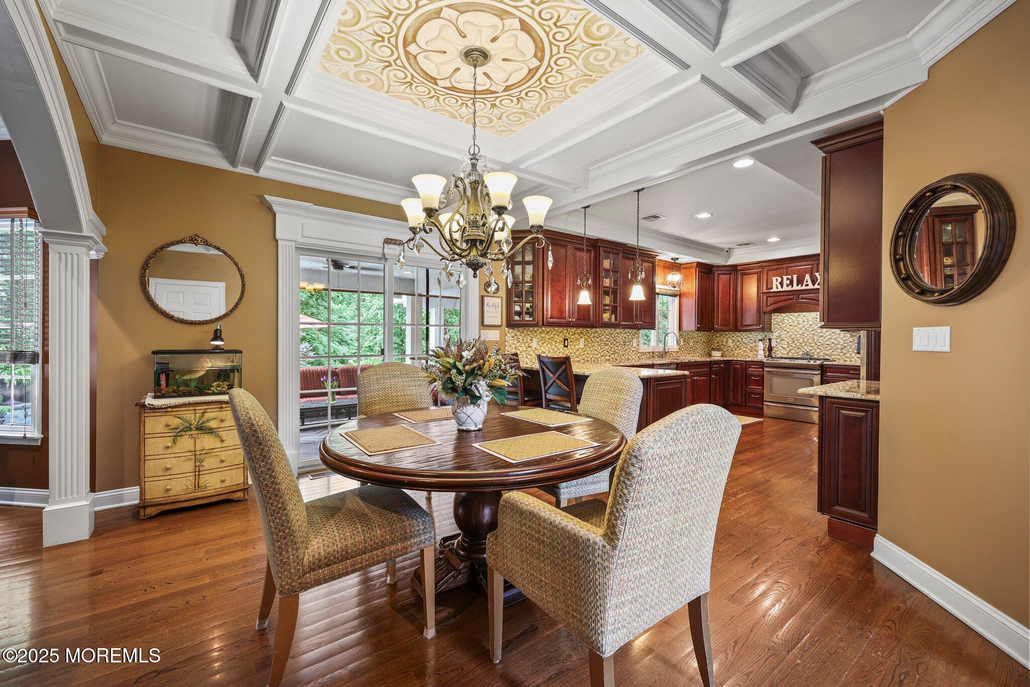 4 White Pines Way Freehold, NJ 07728 - Photo 13 of 66 a view of a dining room with furniture a chandelier and wooden floor