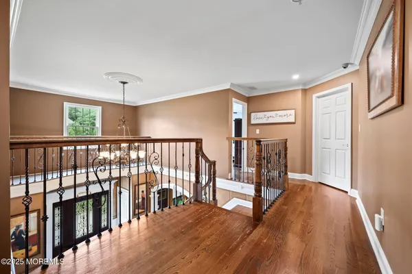 a room with stainless steel appliances wooden floor table and chairs
