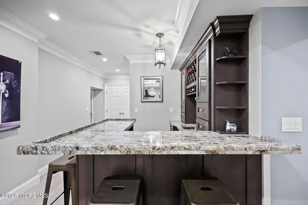 a bathroom with a toilet sink vanity granite and mirror