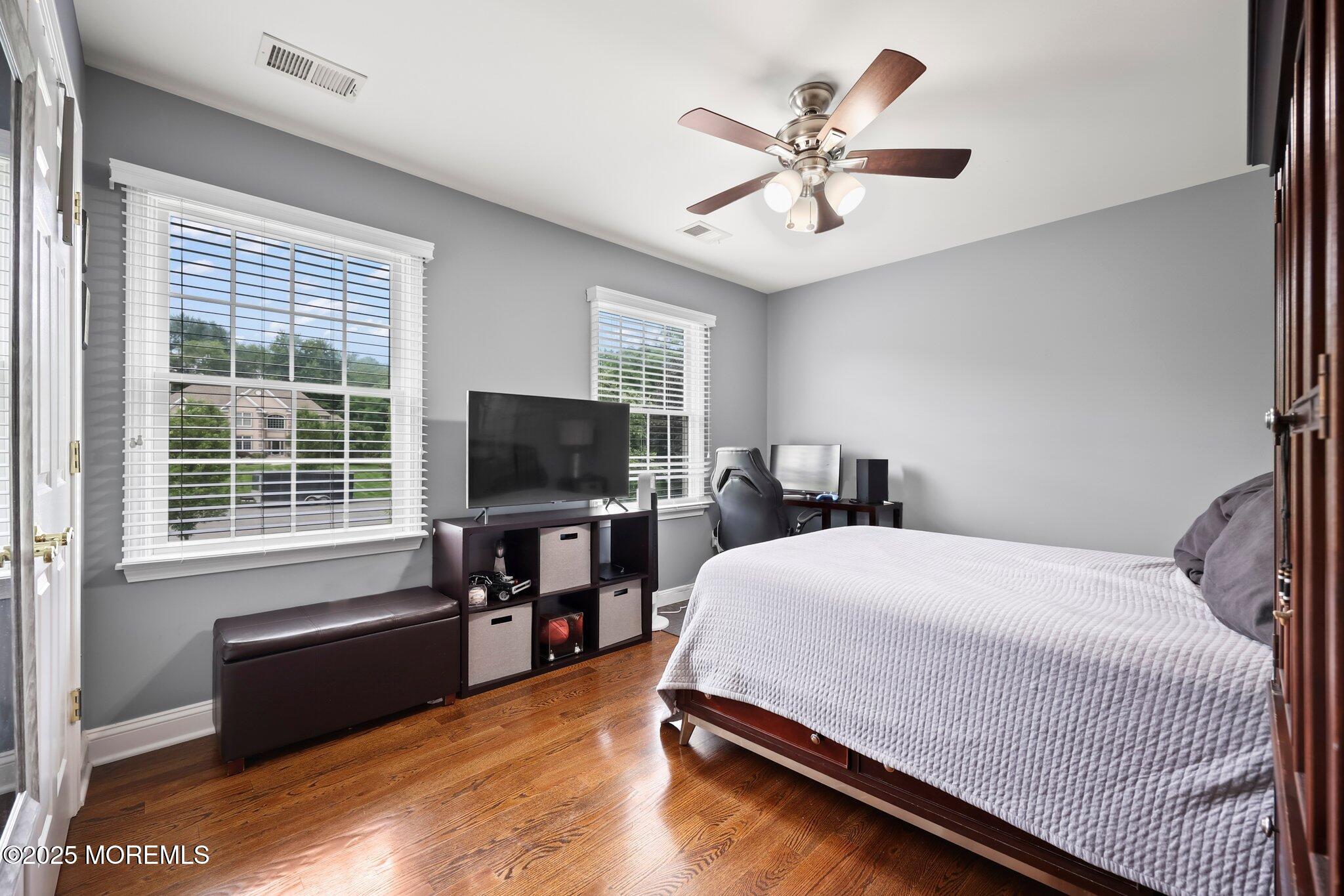 4 White Pines Way Freehold, NJ 07728 - Photo 28 of 66 a bedroom with a bed and a flat screen tv