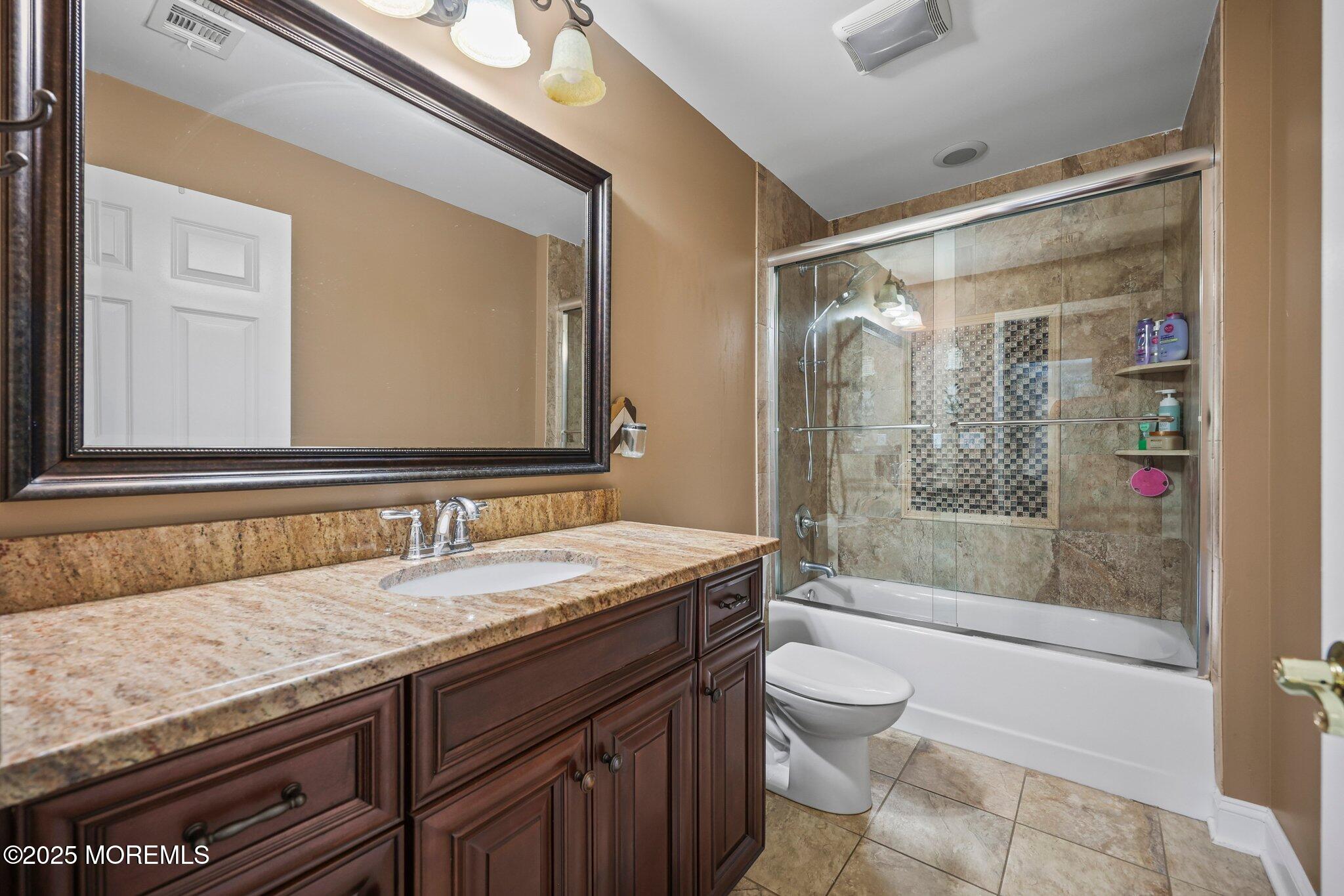 4 White Pines Way Freehold, NJ 07728 - Photo 31 of 66 a bathroom with a granite countertop sink toilet and shower