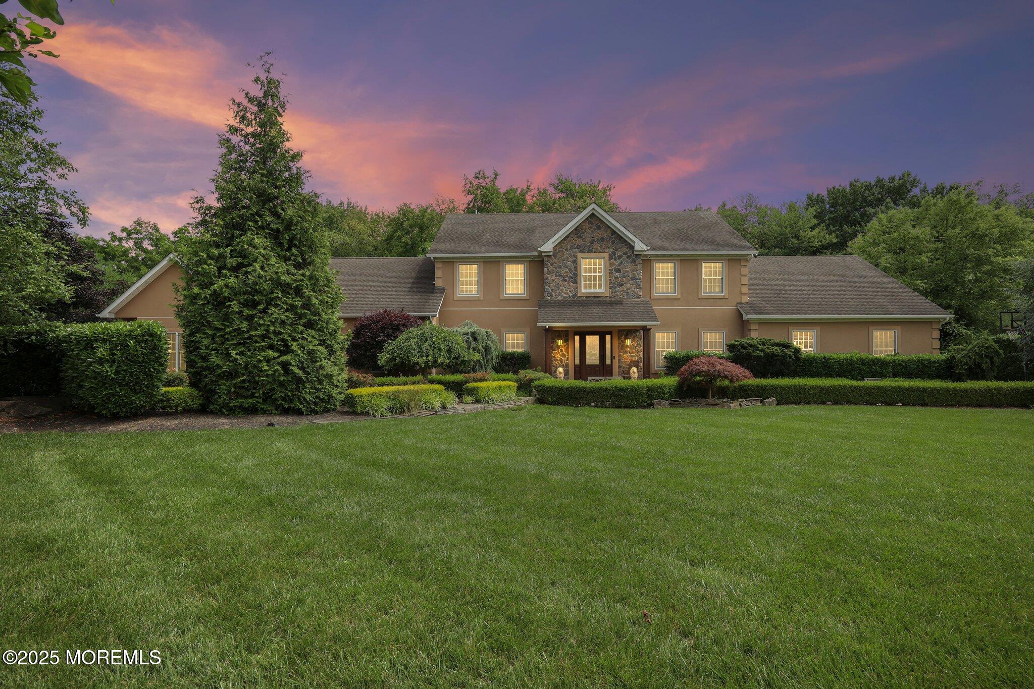 4 White Pines Way Freehold, NJ 07728 - Photo 4 of 66 a front view of a house with a yard