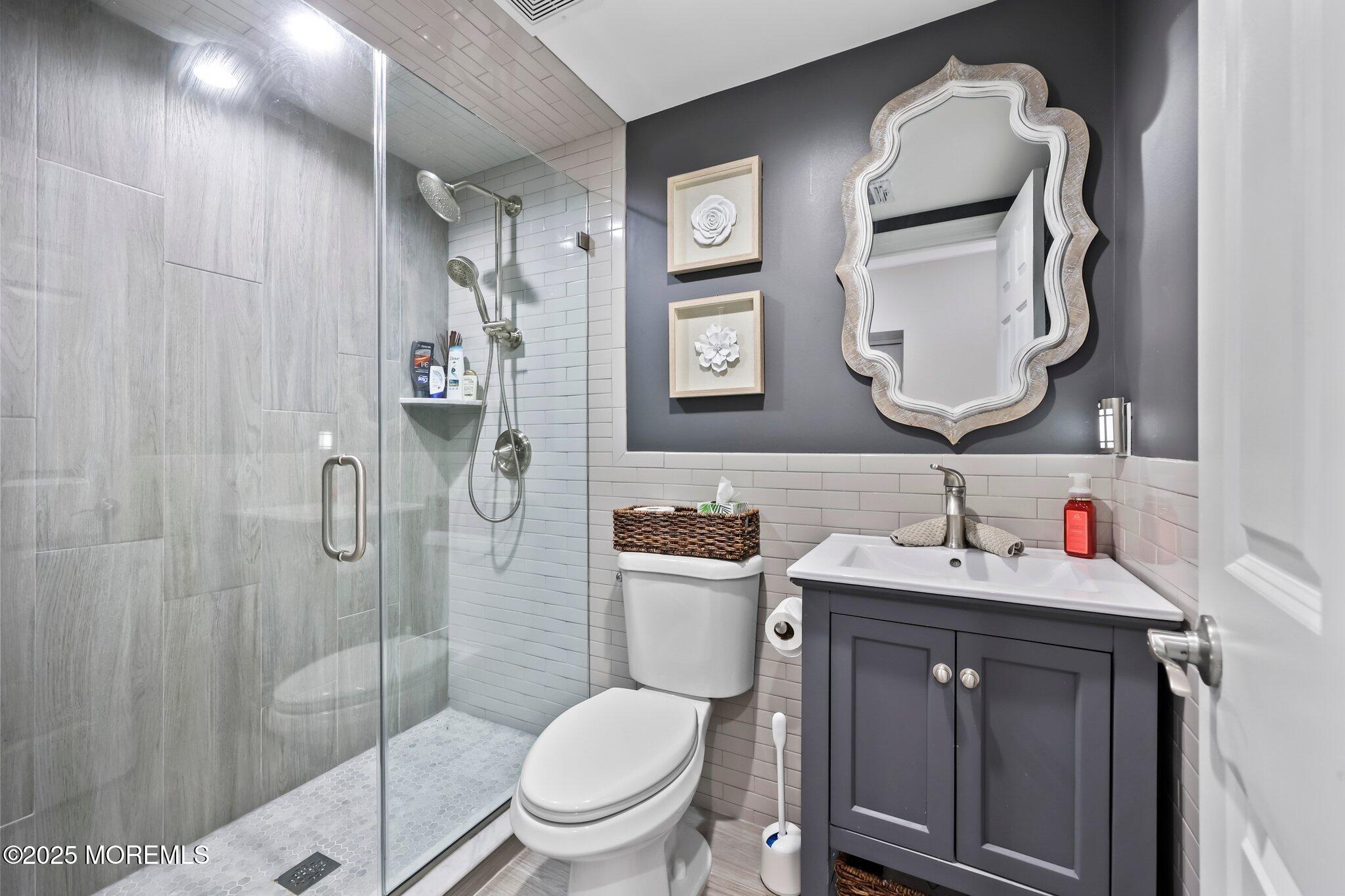 4 White Pines Way Freehold, NJ 07728 - Photo 41 of 66 a bathroom with a toilet sink vanity granite and mirror