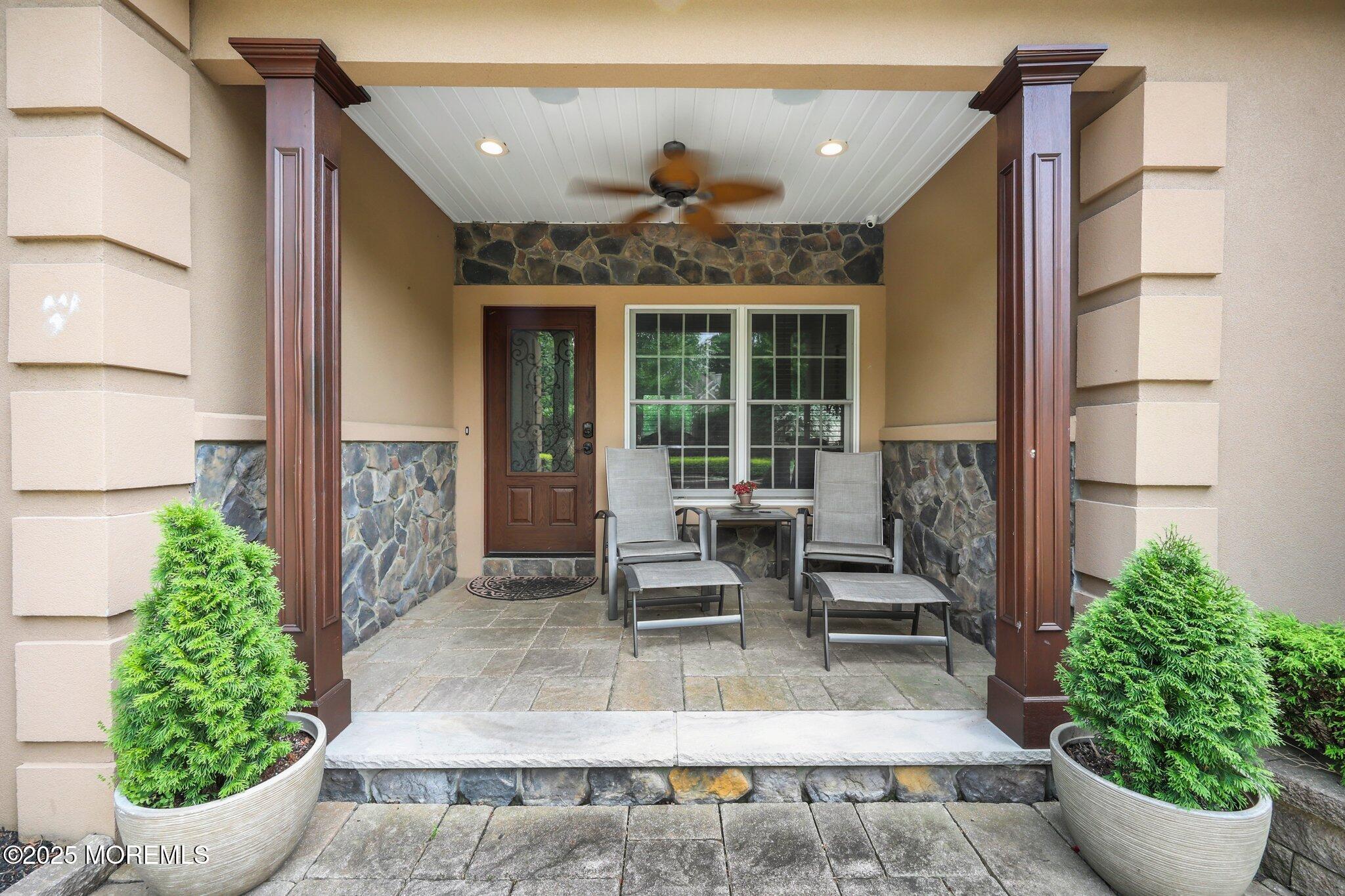 4 White Pines Way Freehold, NJ 07728 - Photo 43 of 66 a view of a patio with table and chairs potted plants with wooden floor