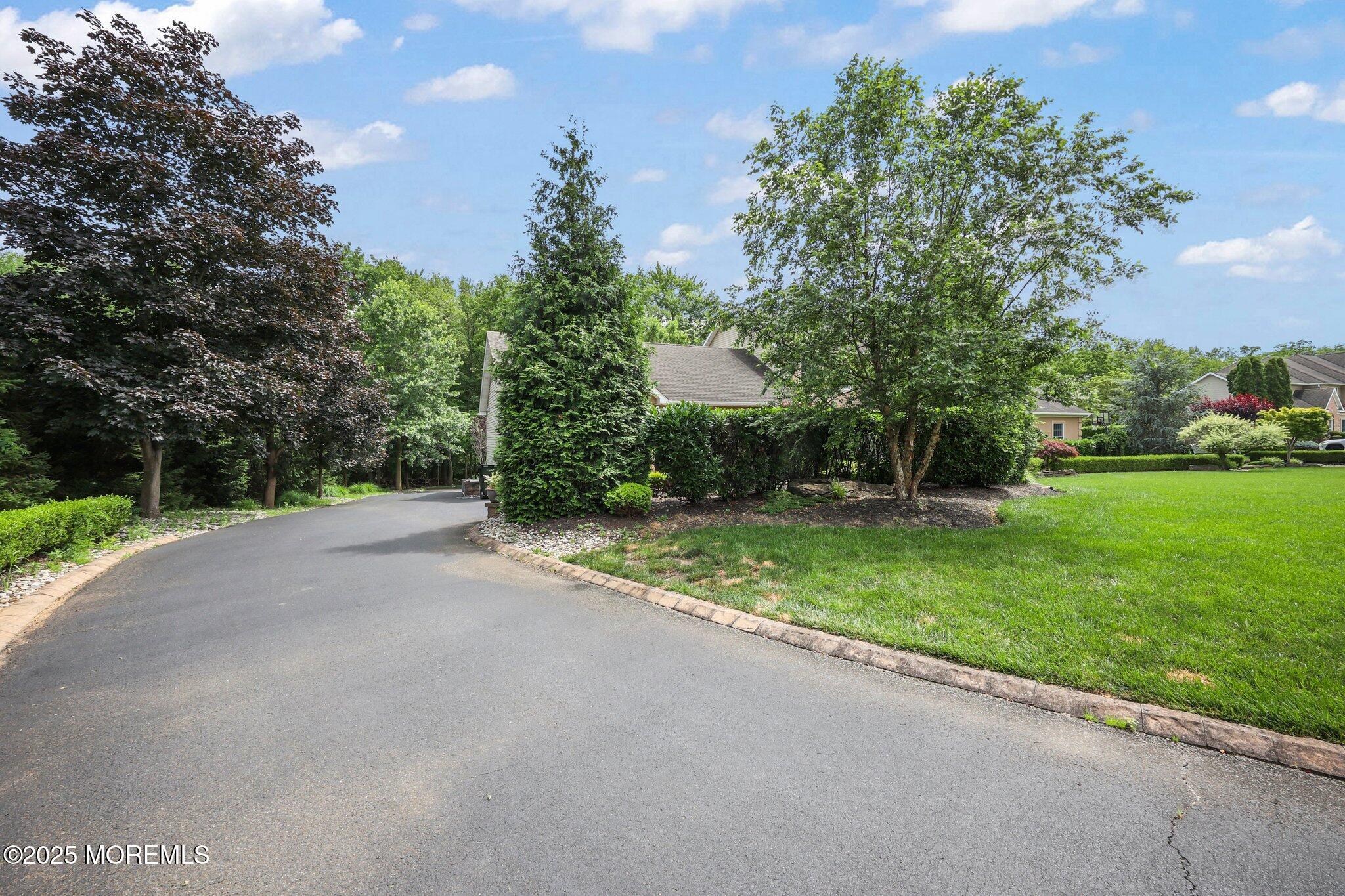 4 White Pines Way Freehold, NJ 07728 - Photo 44 of 66 a view of a street with a yard and large trees