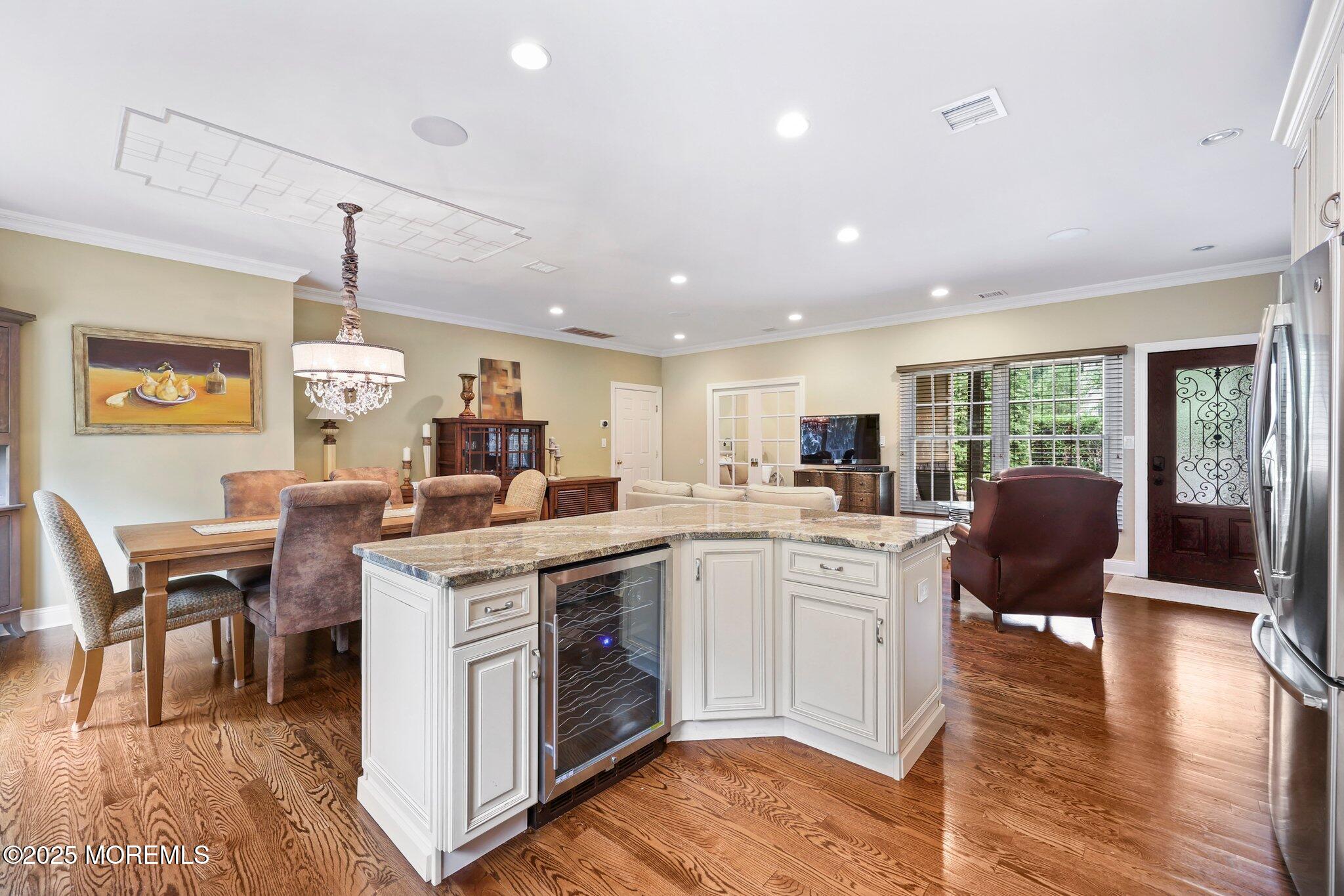 4 White Pines Way Freehold, NJ 07728 - Photo 47 of 66 a kitchen with a table chairs stove and wooden floor