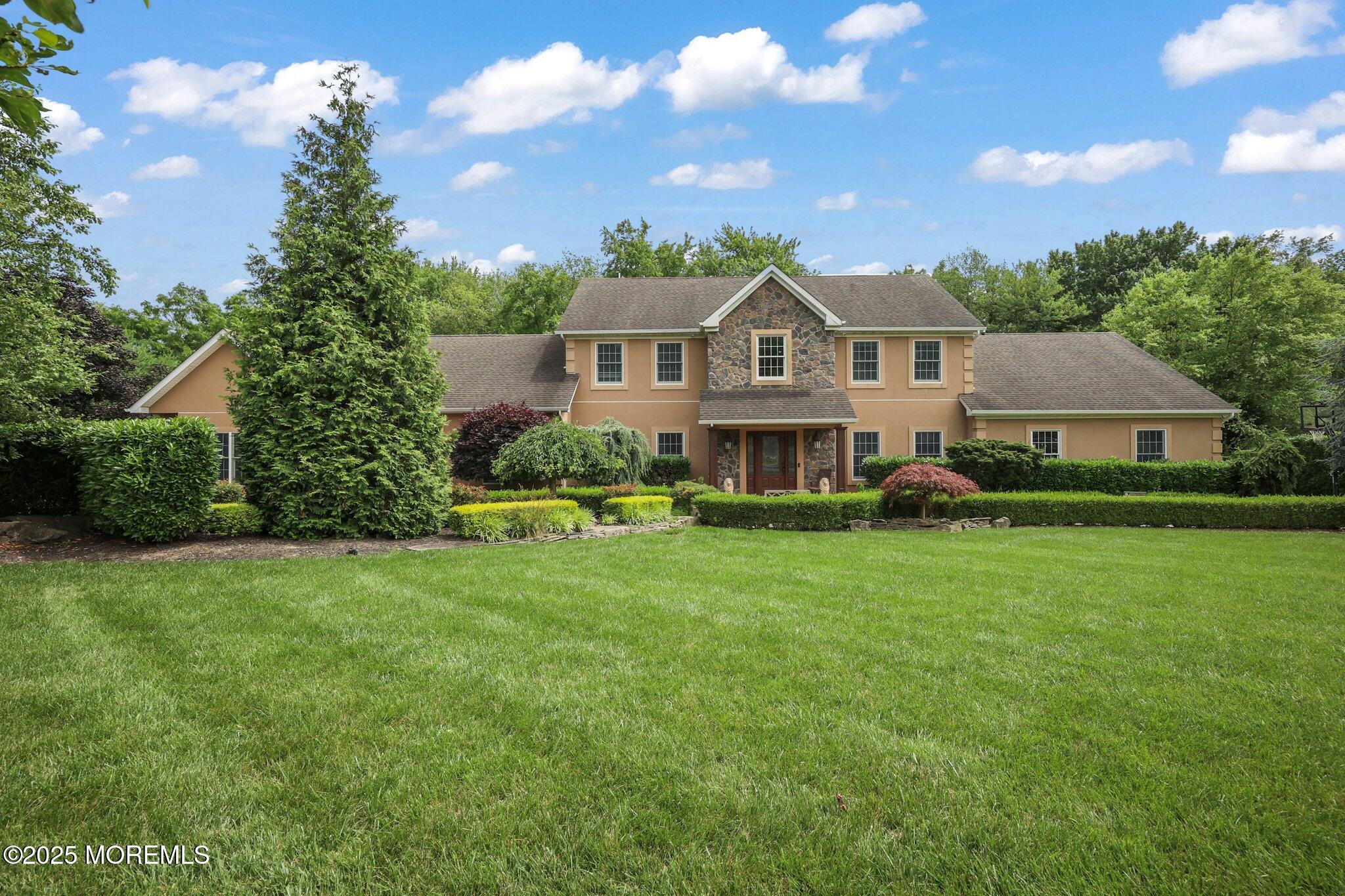 4 White Pines Way Freehold, NJ 07728 - Photo 5 of 66 a front view of a house with garden