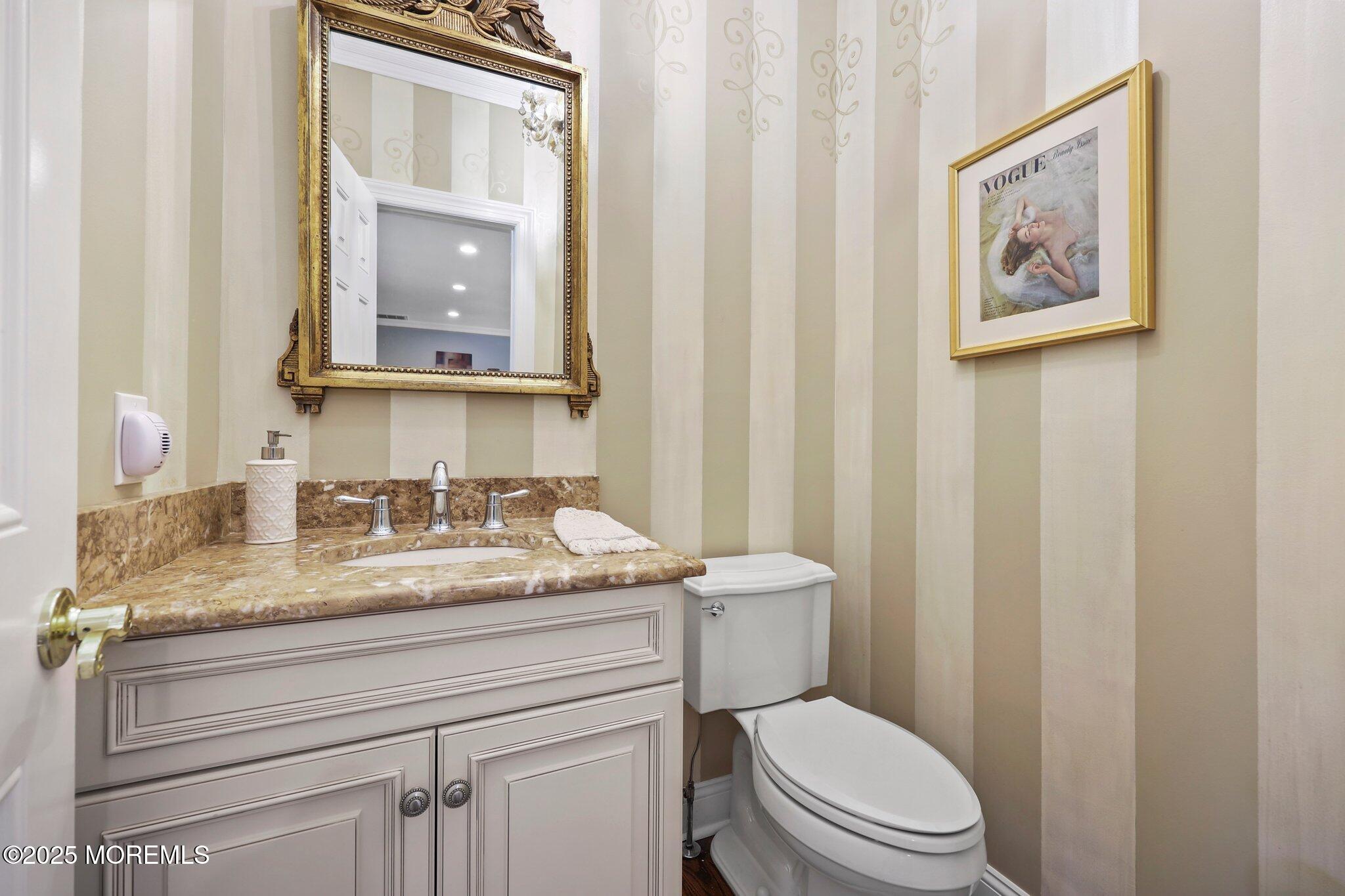 4 White Pines Way Freehold, NJ 07728 - Photo 55 of 66 a bathroom with a granite countertop toilet sink and mirror
