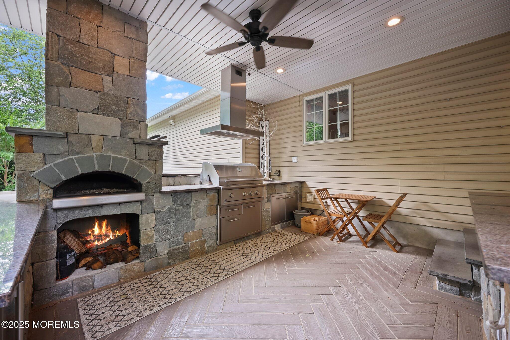 4 White Pines Way Freehold, NJ 07728 - Photo 59 of 66 a dining room with furniture and a fireplace
