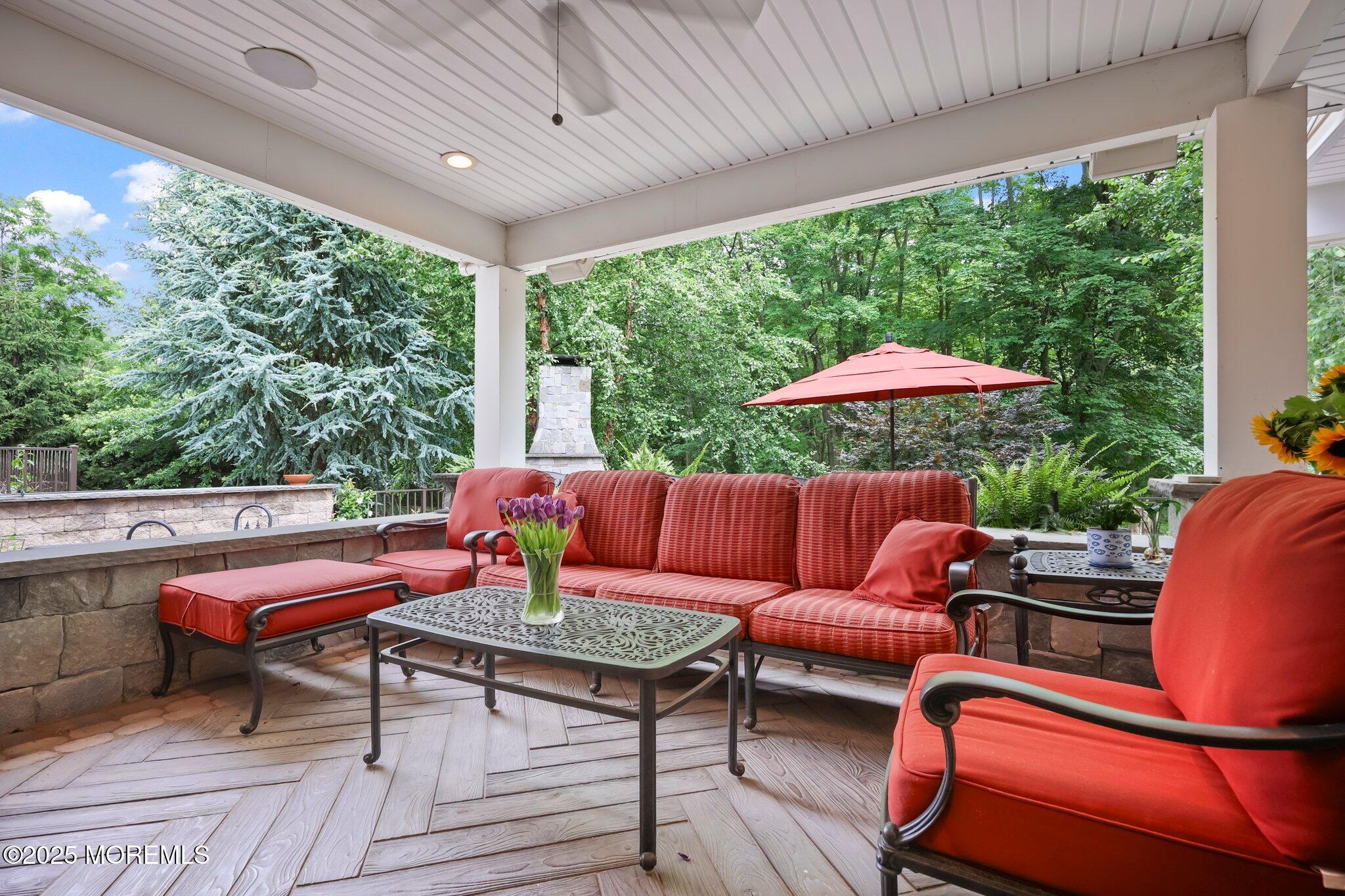 4 White Pines Way Freehold, NJ 07728 - Photo 60 of 66 a outdoor sitting area with furniture and wooden floor