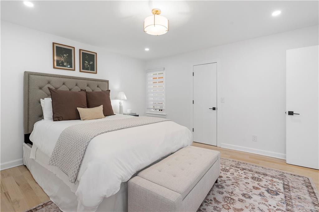403 Rockbridge Road Southwest Lilburn, GA 30047 - Photo 27 of 77 a bedroom with a large bed and a couch