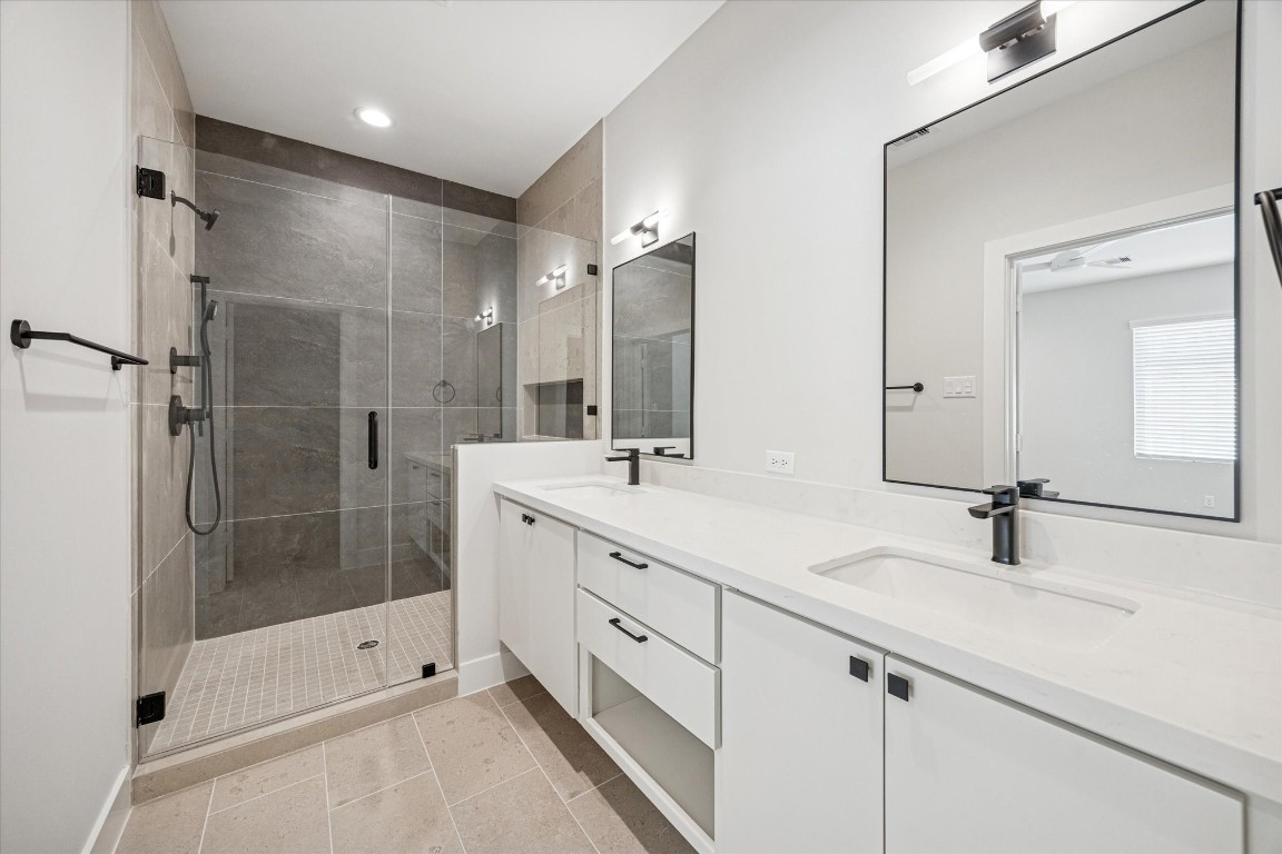 520 Janisch Road Houston, TX 77018 - Photo 15 of 28 The primary bath offers quartz counters and an abundance of storage for keeping all your essentials organized.
