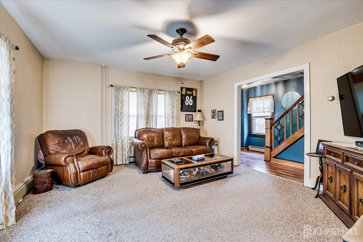 61 Stouts Lane Monmouth Junction, NJ 08852 - Photo 12 of 42 a living room with furniture and a flat screen tv