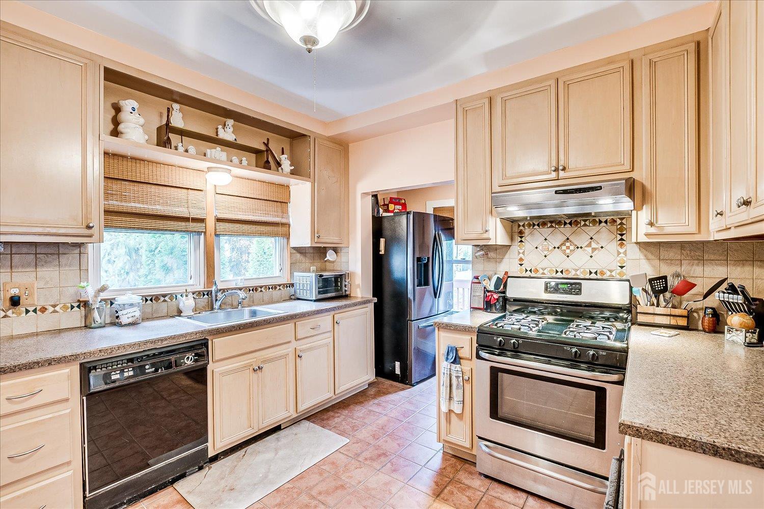 61 Stouts Lane Monmouth Junction, NJ 08852 - Photo 18 of 42 a kitchen with stainless steel appliances granite countertop a stove and a refrigerator
