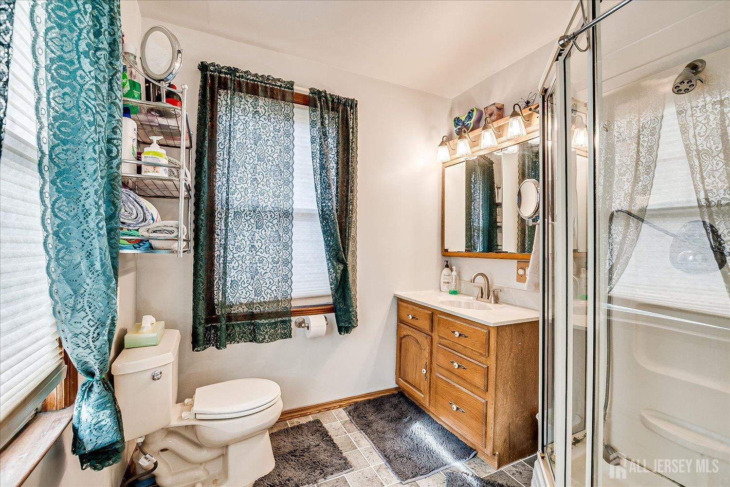 61 Stouts Lane Monmouth Junction, NJ 08852 - Photo 23 of 42 a bathroom with a toilet sink and mirror