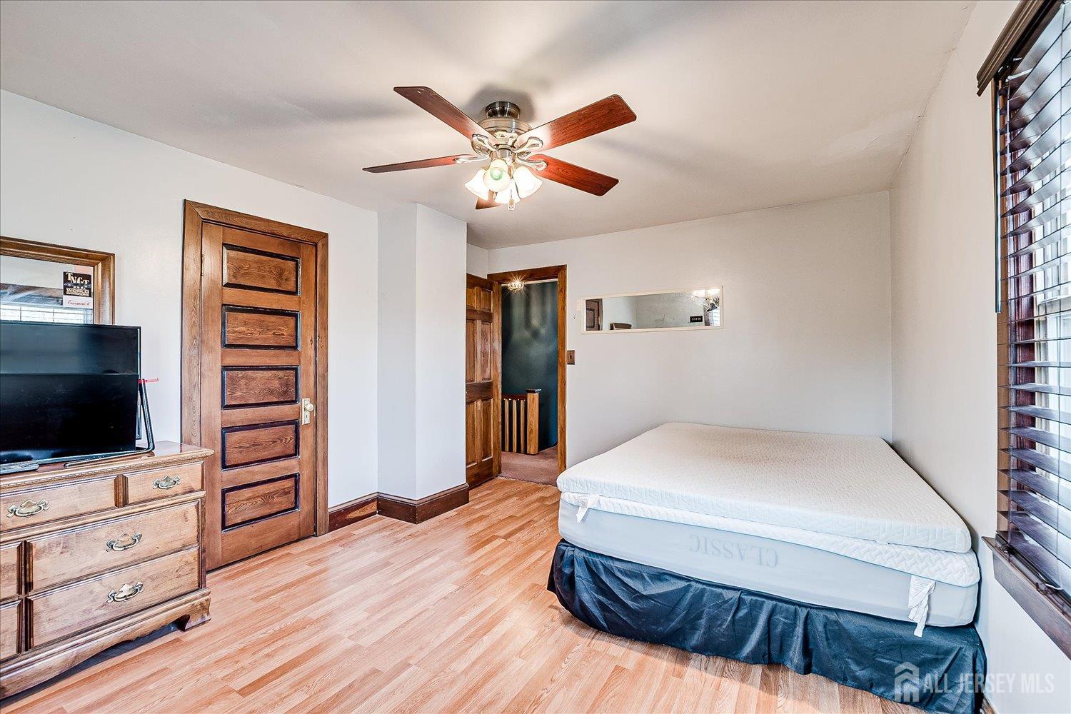 61 Stouts Lane Monmouth Junction, NJ 08852 - Photo 25 of 42 a bedroom with a bed and wooden floor