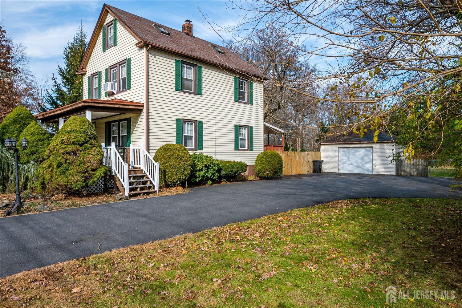 61 Stouts Lane Monmouth Junction, NJ 08852 - Photo 4 of 42 a front view of a house with a yard and garage