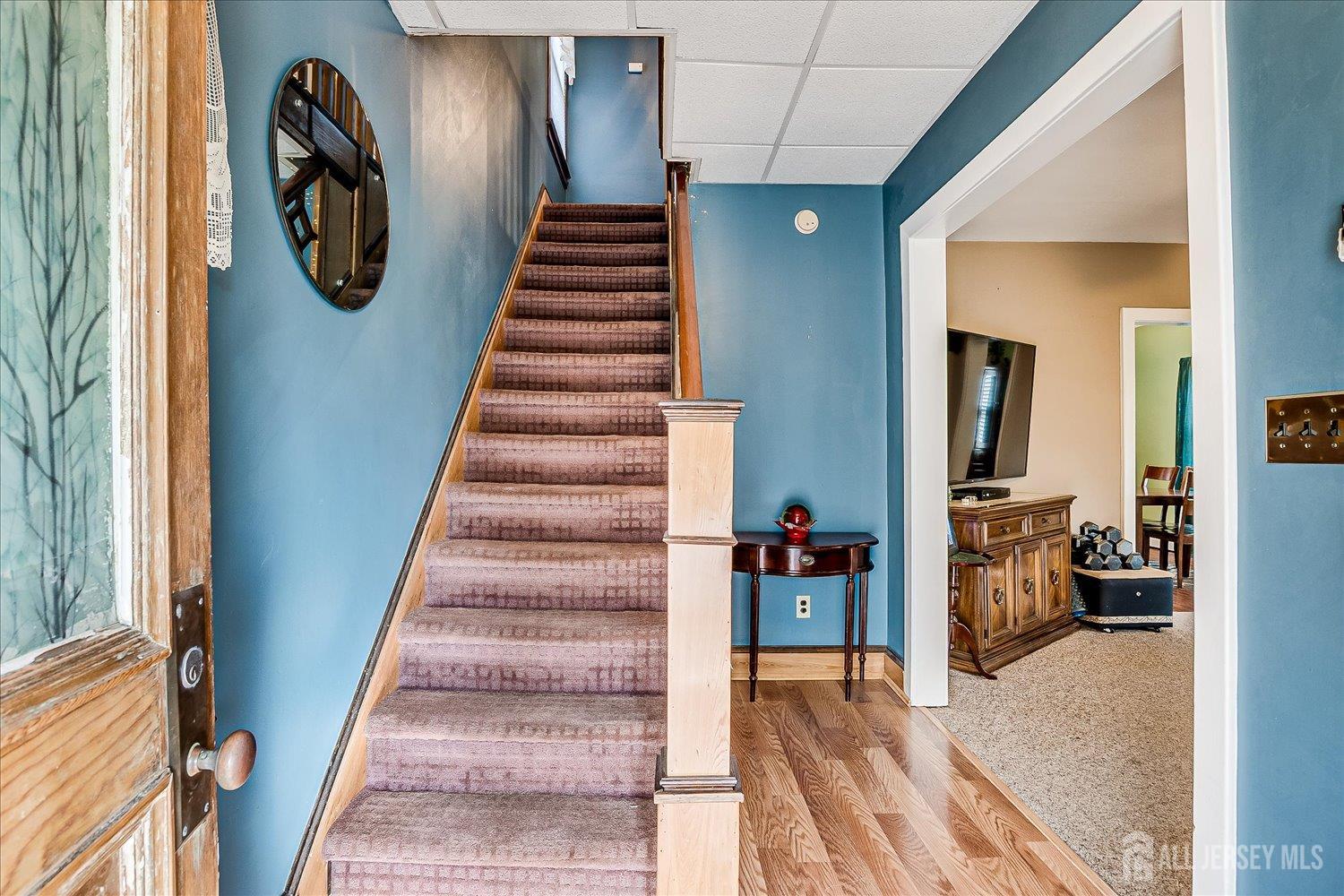 61 Stouts Lane Monmouth Junction, NJ 08852 - Photo 9 of 42 a view of staircase with lots of frames and flower walls