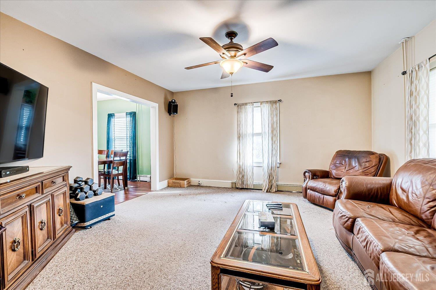 61 Stouts Lane Monmouth Junction, NJ 08852 - Photo 10 of 42 a living room with furniture and a flat screen tv