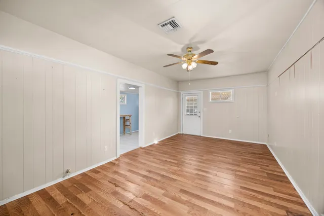 a view of an empty room with a ceiling fan