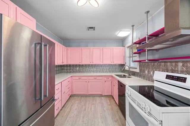 a kitchen with a sink stove and refrigerator