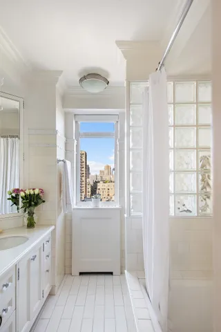 a hallway with view of wooden floor and cabinet
