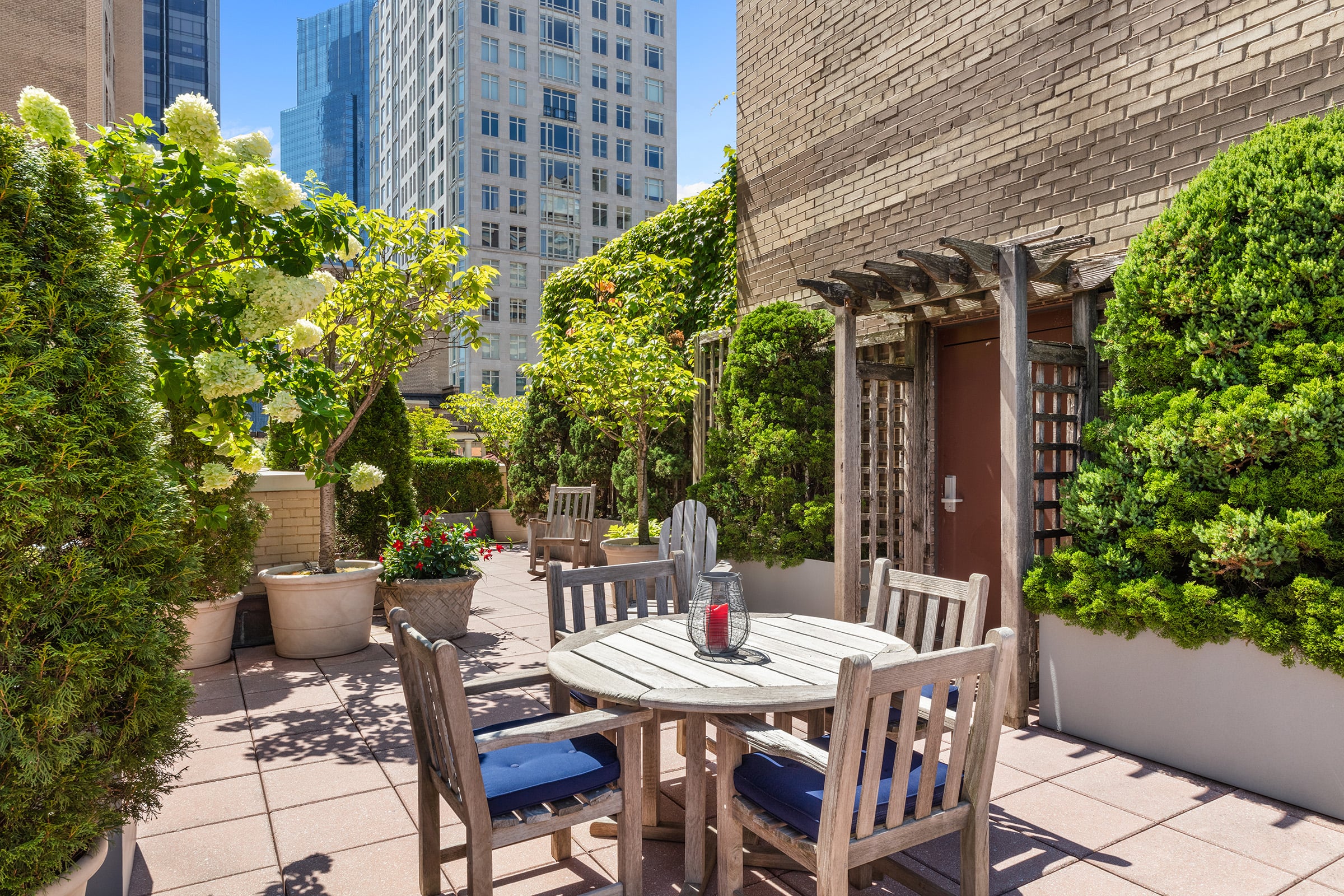 25 Central Park West, Unit 21Q Manhattan, NY 10023 - Photo 15 of 18 a view of a patio with table and chairs and potted plants