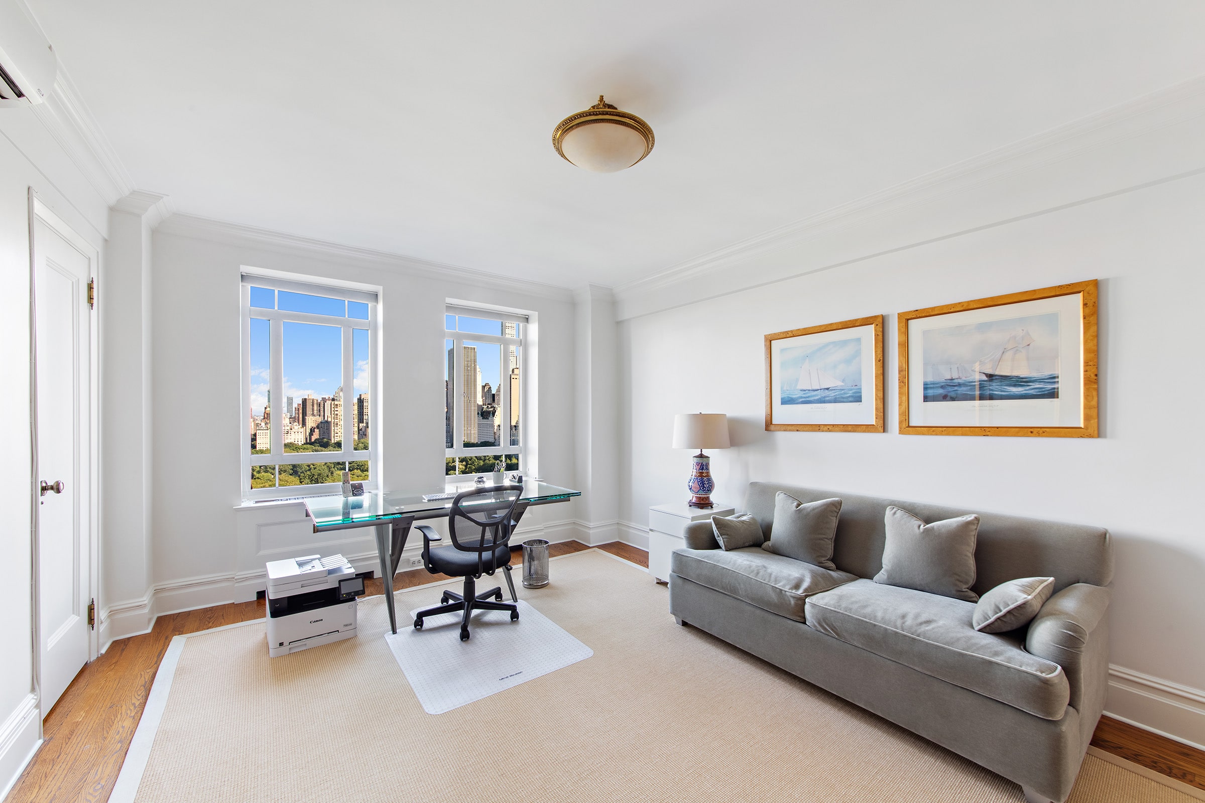25 Central Park West, Unit 21Q Manhattan, NY 10023 - Photo 8 of 18 a living room with furniture and a large window