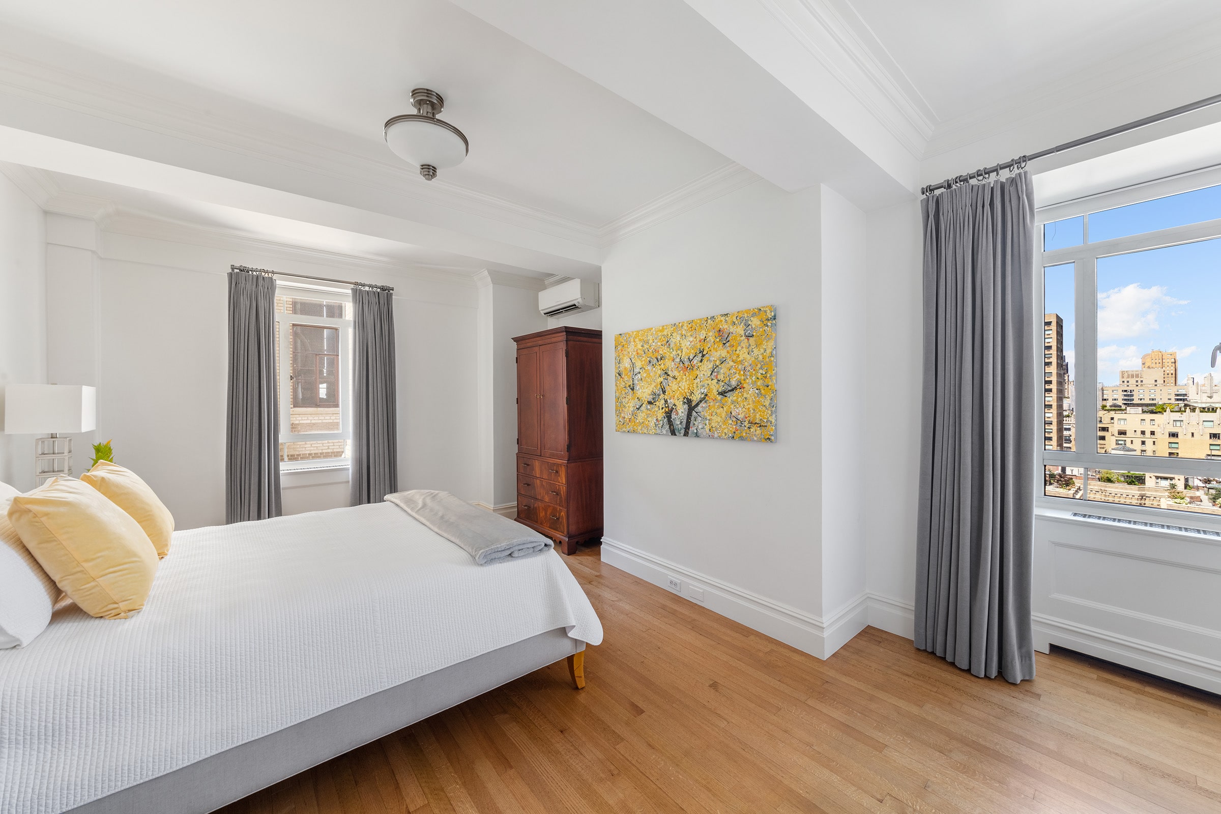 25 Central Park West, Unit 21Q Manhattan, NY 10023 - Photo 9 of 18 a bedroom with a large bed and a window