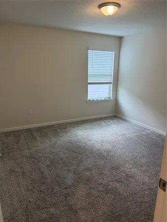 an empty room with a empty space and windows