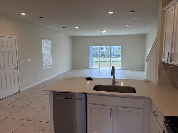 a kitchen with a sink and chandelier