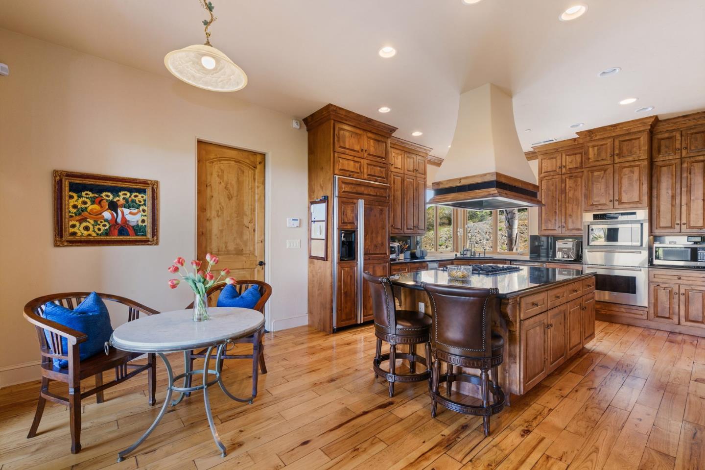 11550 Spur Road Monterey, CA 93940 - Photo 18 of 66 a living room with stainless steel appliances kitchen island granite countertop furniture wooden floor and a kitchen view