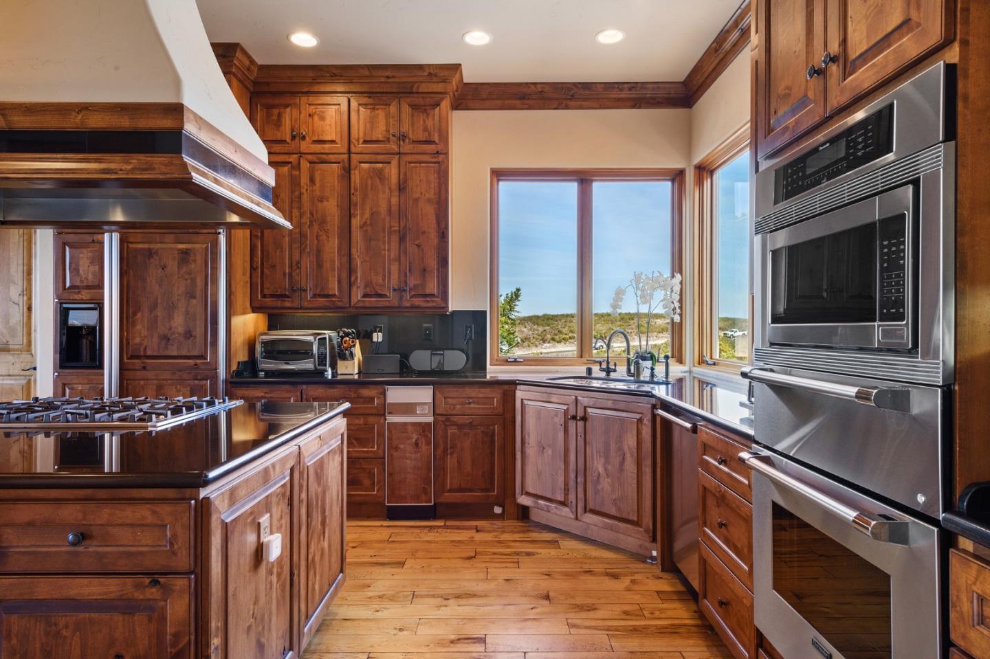 11550 Spur Road Monterey, CA 93940 - Photo 24 of 66 a kitchen with stainless steel appliances granite countertop a sink stove and cabinets