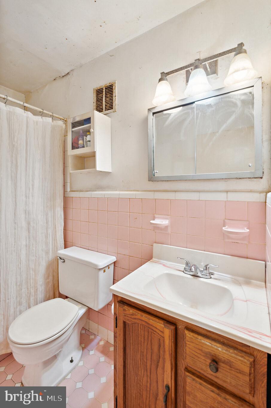 1719 Griffith Street Philadelphia, PA 19111 - Photo 12 of 31 a bathroom with a sink a toilet and a mirror