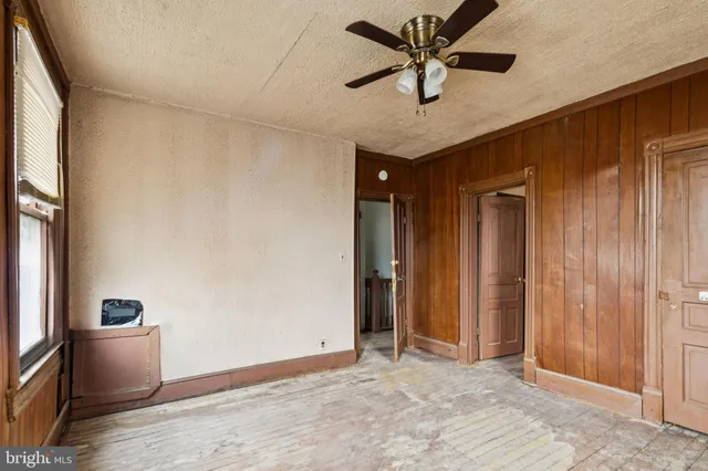 a white bath tub sitting next to a white sink and a toilet