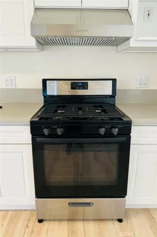 a stove top oven sitting inside of a kitchen
