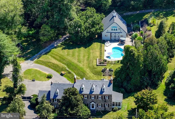 an aerial view of a house with swimming pool garden and patio